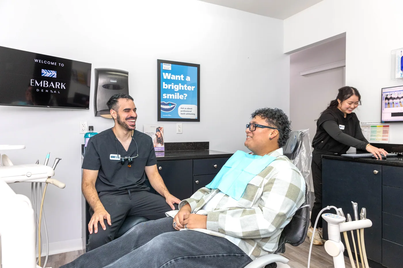 An Embark Dental dentist speaking with a patient in a treatment room