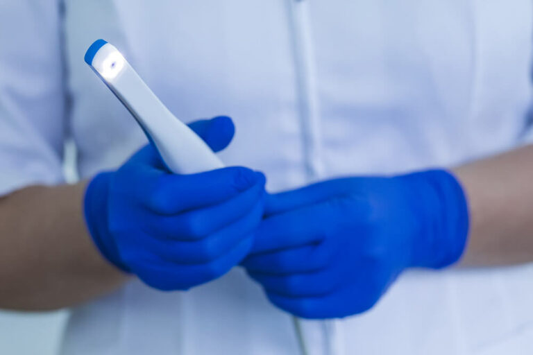 dental technician holding an intraoral camera